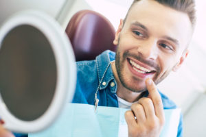 a patient smiling after his professional teeth whitening