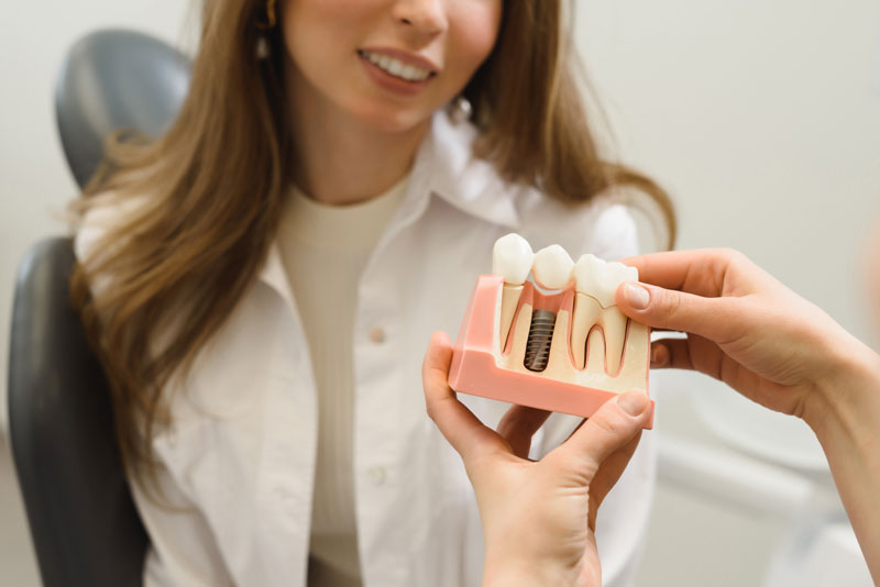 Dental Patient Getting Shown A Dental Implant Model During Her Consultation in Jacksonville, FL