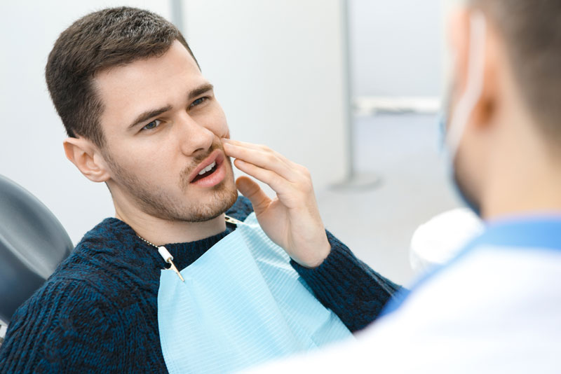 Dental Patient Suffering From Mouth Pain On A Dental Chair, In Jacksonville, FL