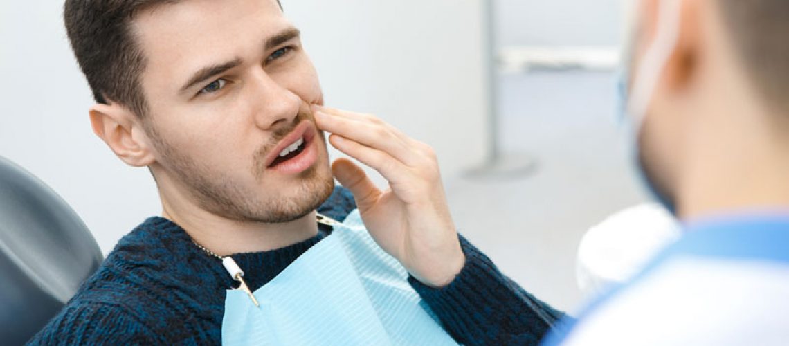 Dental Patient Suffering From Mouth Pain On A Dental Chair, In Jacksonville, FL